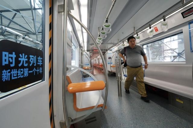 Students play online games inside a subway train in Beijing